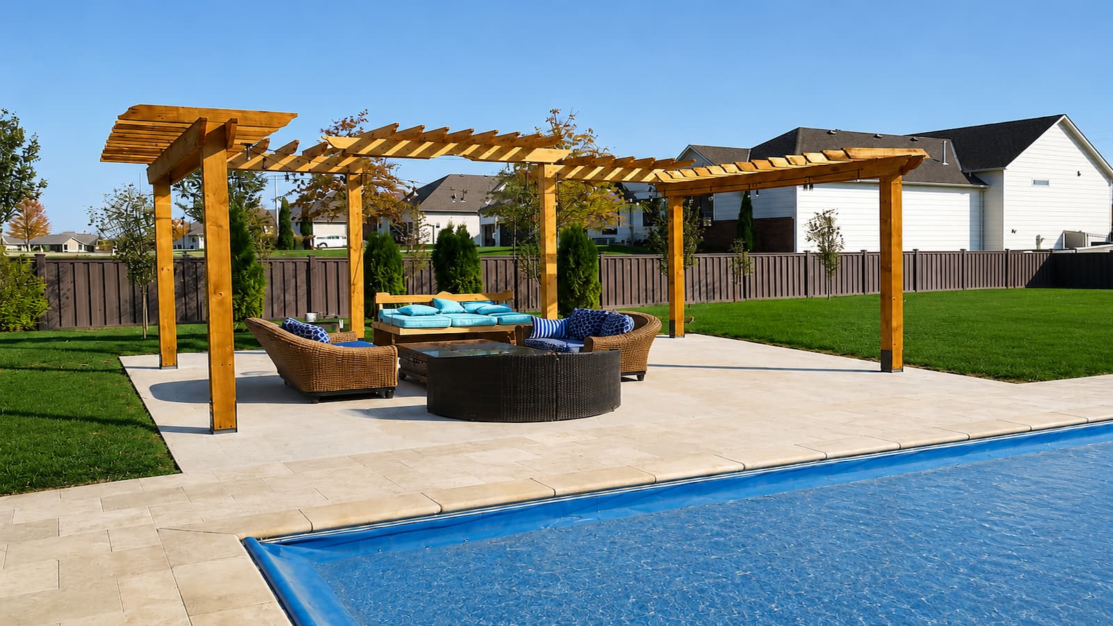 Wood pergola over a poolside patio built by Jayhawk Construction
